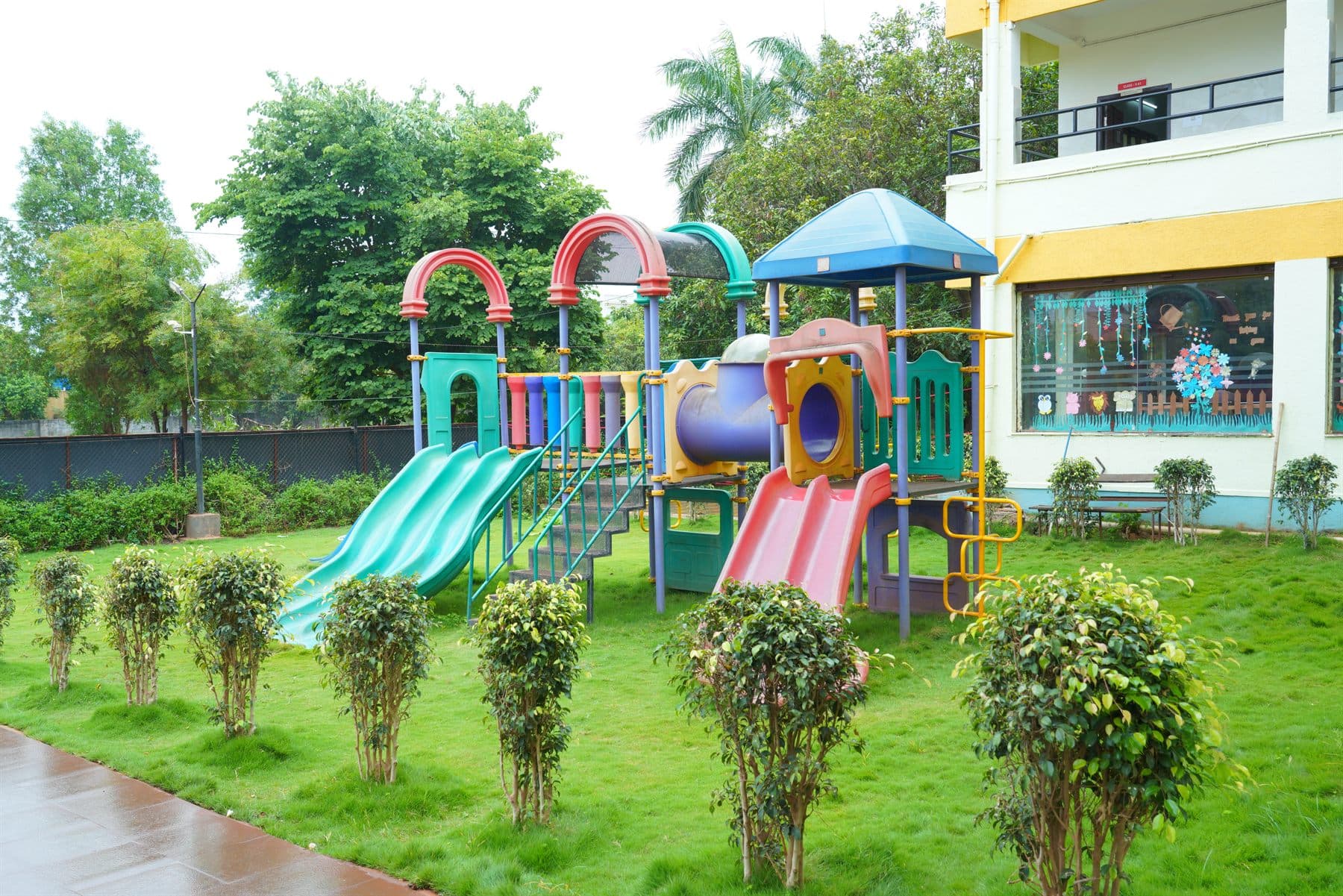 Outdoor playground equipment beside the school building